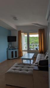 a living room with a couch and a table at Guest House Chalakov in Sinemorets