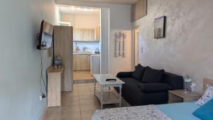 a living room with a couch and a kitchen at Guest House Chalakov in Sinemorets