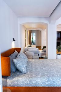 a bedroom with a bed and a living room at Thome Continental Suite in Cluj-Napoca