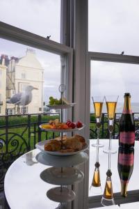 a table with a plate of food and wine glasses at Square Townhouse in Brighton & Hove