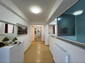a hallway with a bathroom with a large mirror at Vila Kasemi in Fier