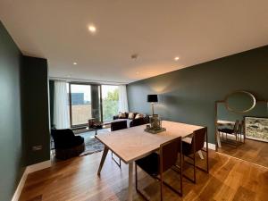 a living room with a table and a couch at The Card Room at Ryedale House in York