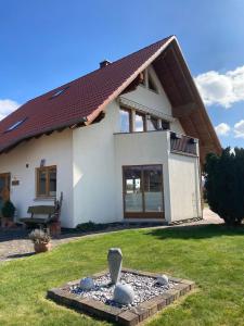 a house with a bird bath in front of it at Haus Wesertal in Lauenförde
