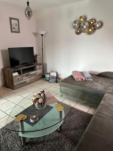 a living room with a couch and a glass table at Haus Wesertal in Lauenförde