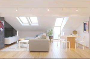 a living room with a white couch and a table at Apartman Centrala in Pirot