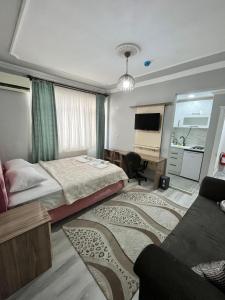 a hotel room with two beds and a couch at YALı APART HOTEL in Trabzon