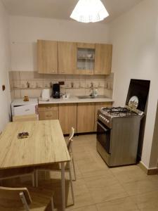 a kitchen with a table and a stove top oven at Apartament Costescu 2 in Băile Herculane