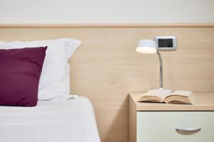 Postel nebo postele na pokoji v ubytování Bella Villa Apartments