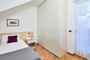 Postel nebo postele na pokoji v ubytování Bella Villa Apartments