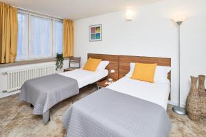 Postel nebo postele na pokoji v ubytování Bella Villa Apartments