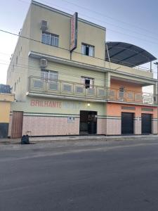 a building with a sign on the side of it at Hotel Brilhante 2 in Itacarambi