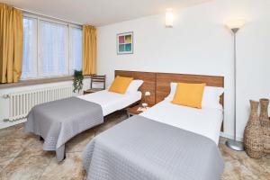 Postel nebo postele na pokoji v ubytování Bella Villa Apartments