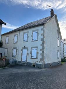 a large white brick house with white windows at La Maison de Marie in Biollet