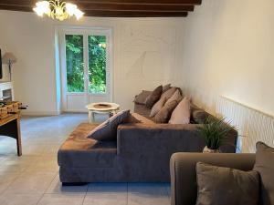 a living room with a couch and a table at La Maison de Marie in Biollet
