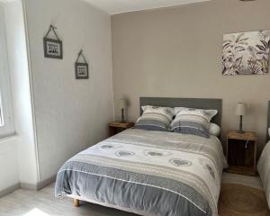 a bedroom with a large bed with two night stands at La Maison de Marie in Biollet