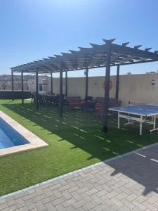 a patio with a ping pong table and a pool at Magic View ماجيك فيو in Al Salt