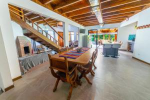 a dining room with a table and a staircase at Casa Violeta Home rentals in Monteverde Costa Rica