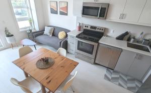 a kitchen and living room with a table and a couch at KozyStay Toronto in Toronto