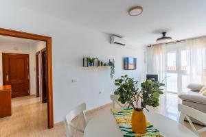 a white living room with a table and chairs at Apartamento Paquita R&R in Aguadulce +43 photos