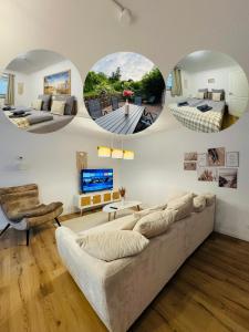 a living room with a couch and two circular mirrors at Charmante Ferienwohnung in Scharbeutz -Ihr perfektes Zuhause am Meer! Terasse, Parken & Strand! W1 in Scharbeutz