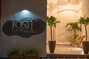 a sign for a lost laundry room with plants at IOSIF LUXURY ROOMS CENTER in Neos Marmaras