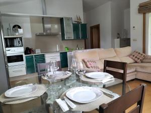 a living room with a table with plates and wine glasses at A casa do castaño in Nigrán +3 photos