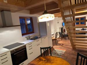 a kitchen with a table and a dining room at Rustici Maggia in Aurigeno