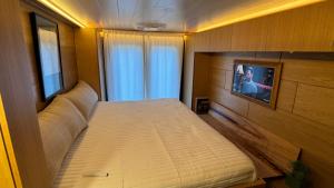 a bedroom with a bed and a tv in it at City Hideaway, Off Grid Luxe in Lancaster