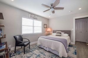 a bedroom with a bed and a ceiling fan at Anchorage Haus in Fredericksburg