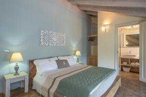 a bedroom with a bed with a laptop on it at Palascìa Wellness Relais in Otranto