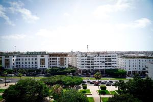 a view of a city with buildings and a parking lot at AZ hôtel des arts in Rabat