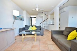 a living room with a couch and a table at Riverview Holiday Apartment 9 - Kalbarri WA in Kalbarri