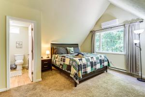 a bedroom with a bed and a window at Furnished Deck and Fire Pit Poconos Outdoorsy Gem in Albrightsville