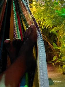 a person with their feet on a hammock at Guest House Boki da Zezé in Marau