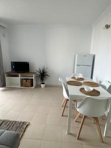 a white dining room with a white table and chairs at Zen Apartment Tenerife in San Miguel de Abona