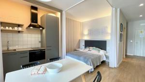a kitchen and a bedroom with a bed in a room at The Cliffs A Ribeira - Polas in Foz