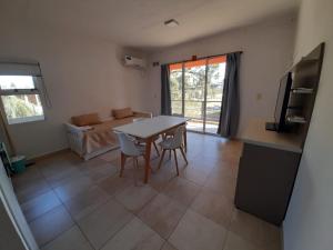 a living room with a table and chairs and a couch at Puerto Termas in Colón