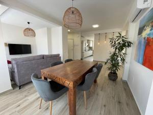 a living room with a wooden table and chairs at Aceni in Ciudad Real