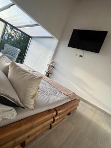 a bedroom with a bed with a large window at Hotel Campestre el Volcan De Guatape in Guatapé