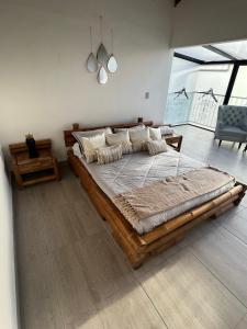 a bedroom with a large wooden bed in a room at Hotel Campestre el Volcan De Guatape in Guatapé