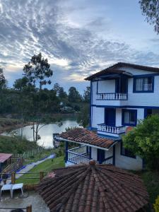 a blue building with a view of a river at Hotel Campestre el Volcan De Guatape in Guatapé