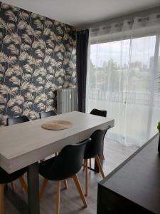 a dining room with a table and chairs at La Cornée Renard in Saint-Dizier