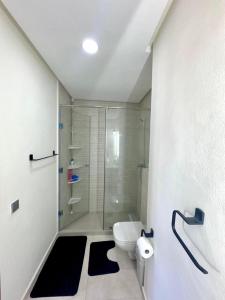 a bathroom with a glass shower and a toilet at Appartement a zenata ain-harrouda casablanca in Mohammedia +6 photos