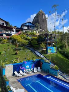 a pool at a resort with a dome in the background at Hotel Campestre el Volcan De Guatape in Guatapé