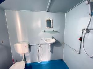 a bathroom with a toilet and a sink and a mirror at Beach Shack Tioman - Beachfront Seaview in Tioman Island +55 photos