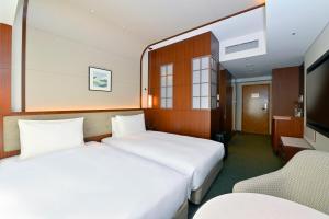 Postel nebo postele na pokoji v ubytování Marunouchi Hotel