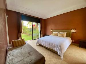 a bedroom with a large bed and a window at Luxueuse villa Proche Agadir et Taroudant pour 6 pers Piscine Privée sans vis à vis in Agadir +34 photos