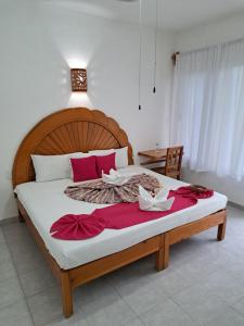a bedroom with a large bed with red pillows at Hotel Quinta Paraiso in Cocoyoc +106 photos