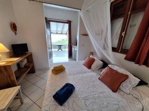 a bedroom with a large bed in a room at Petite Anse in Terre-de-Haut +2 photos
