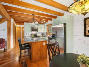 a kitchen with a table and chairs and a refrigerator at Gated neighborhood - Hot Tub & Fire Pit in Nebo